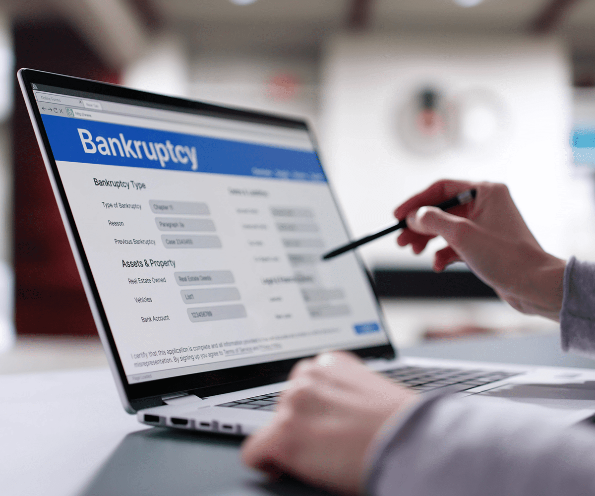 Person filling out bankruptcy form on laptop.