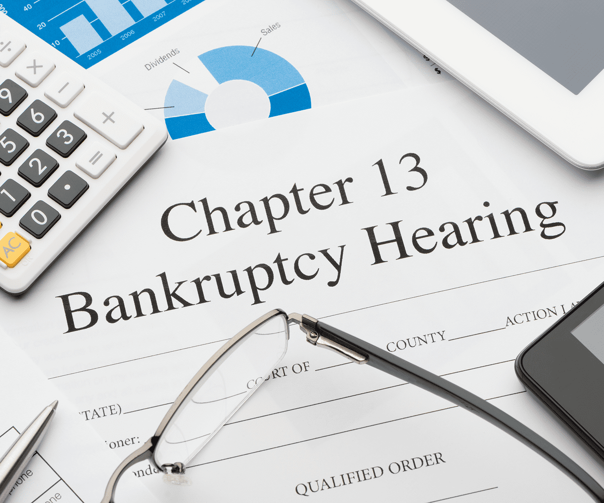 Chapter 13 bankruptcy hearing document with glasses.