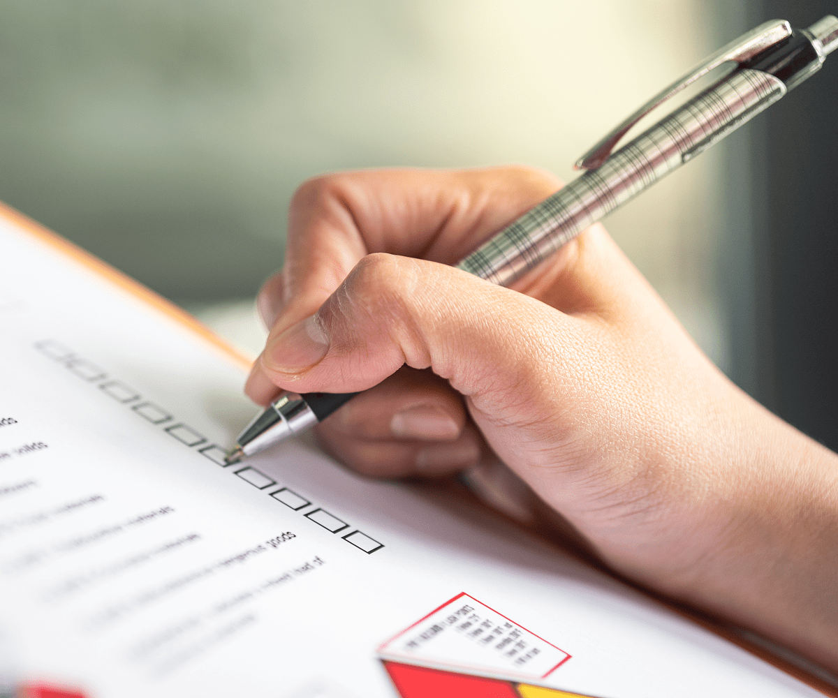 Hand writing on a checklist form.