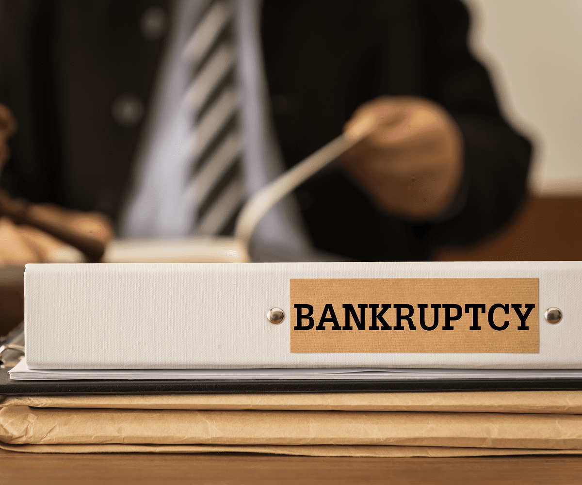 Bankruptcy binder on desk with gavel.