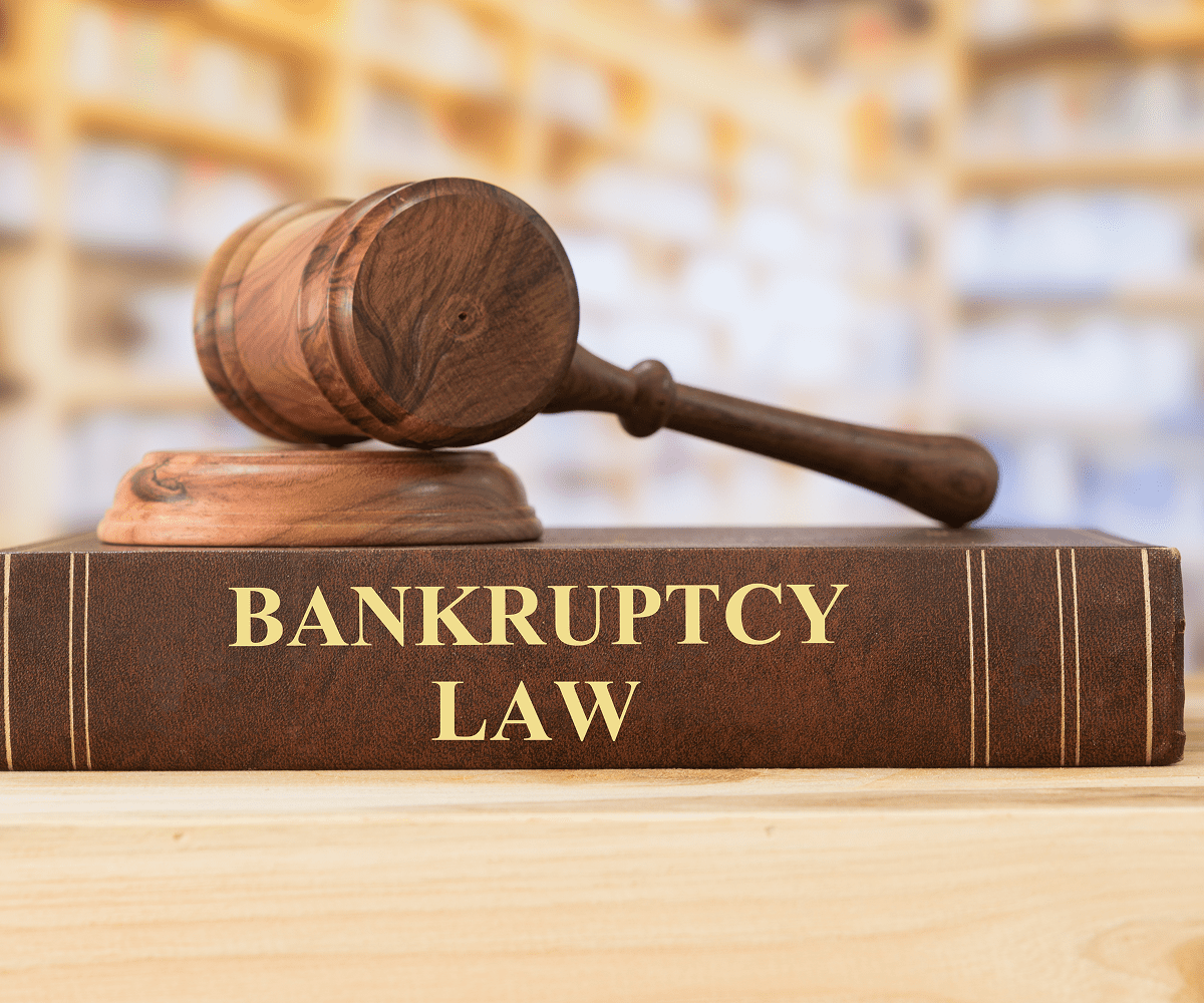 Gavel resting on bankruptcy law book.