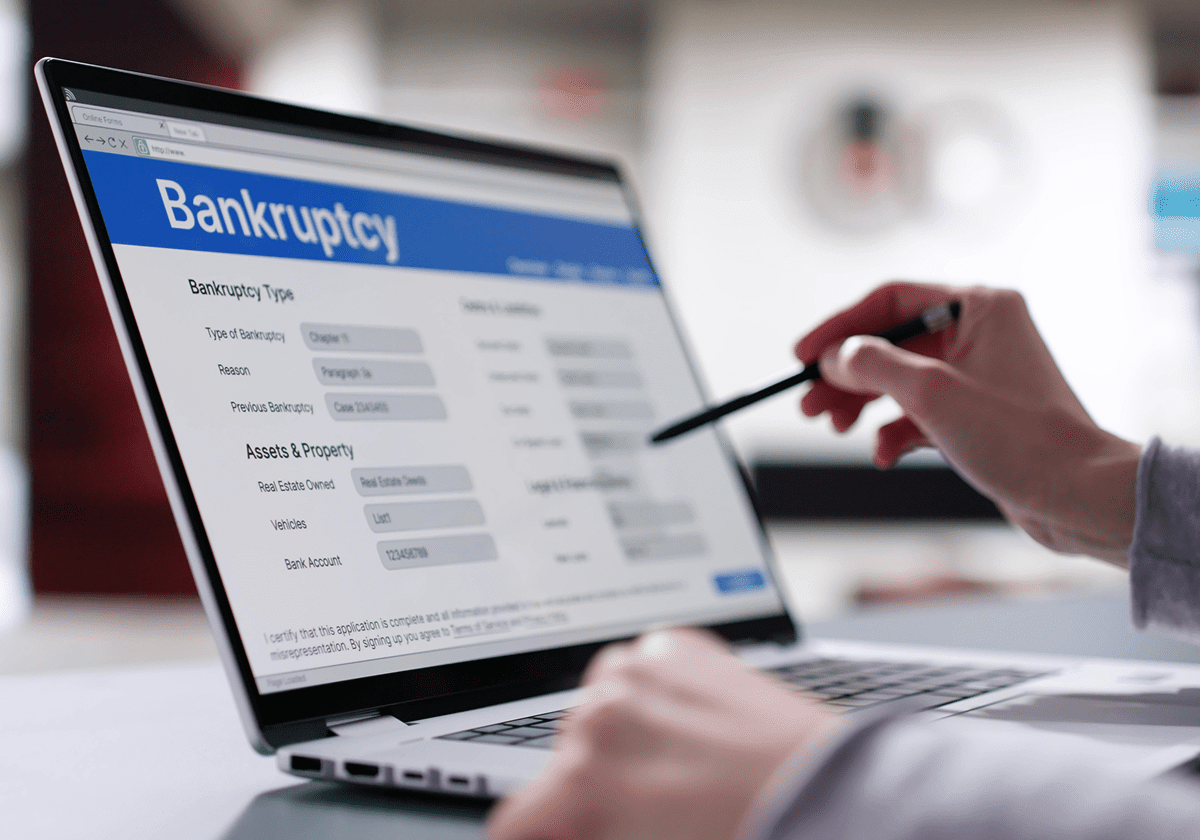 Person filling out bankruptcy form on laptop.