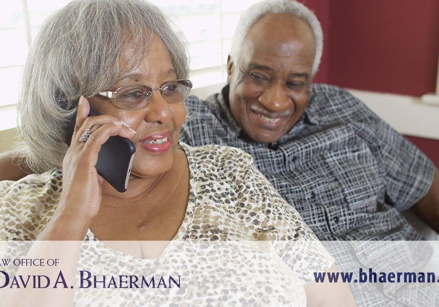 Elderly couple smiling, woman on phone.