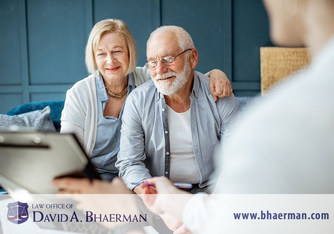 Elderly couple consulting with legal advisor.
