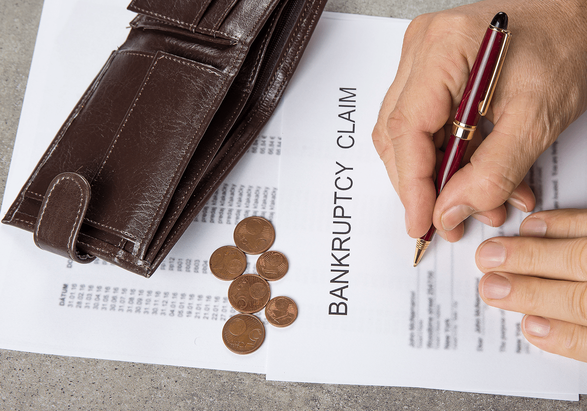 Bankruptcy claim document with coins and wallet.