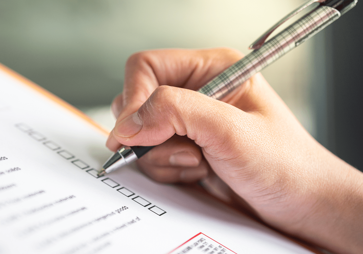 Hand writing on a checklist form.