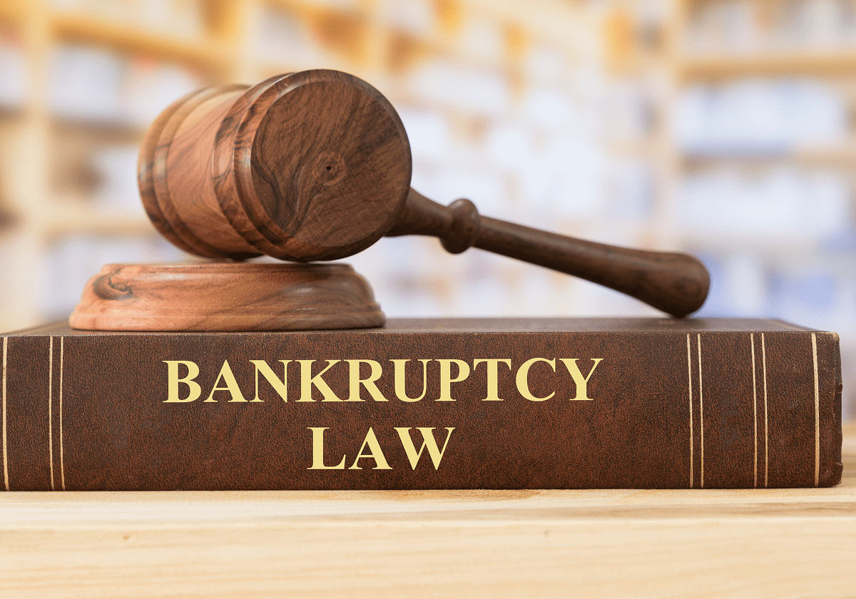 Gavel resting on bankruptcy law book.