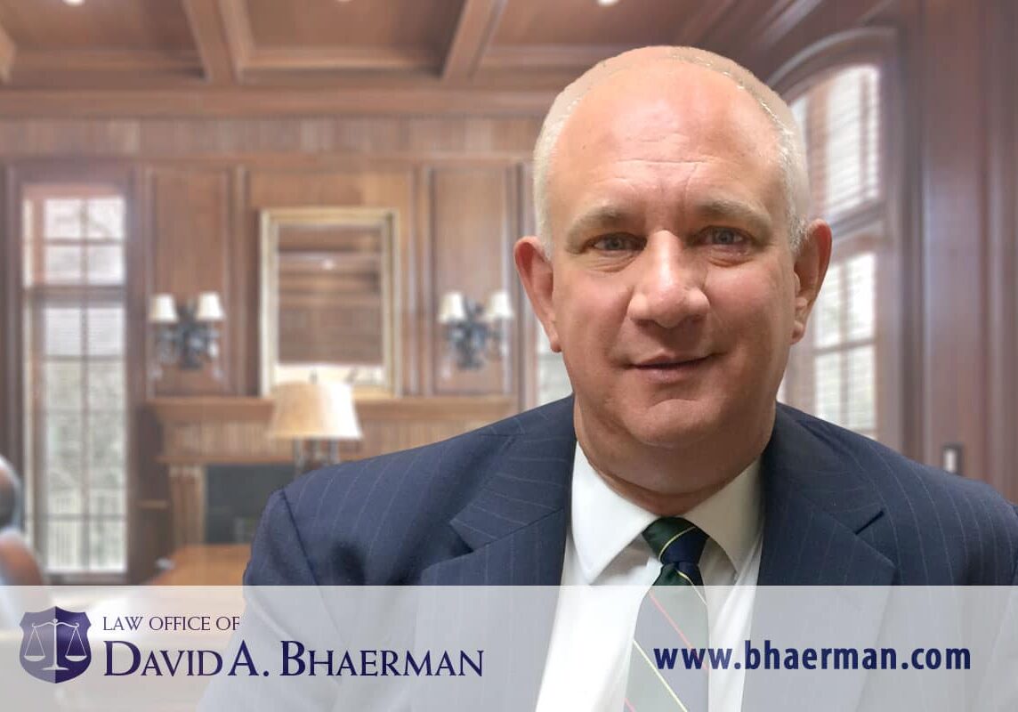 Man in office with law firm branding.