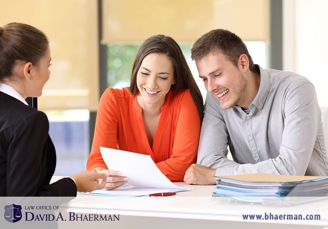 Couple reviewing documents with a lawyer.