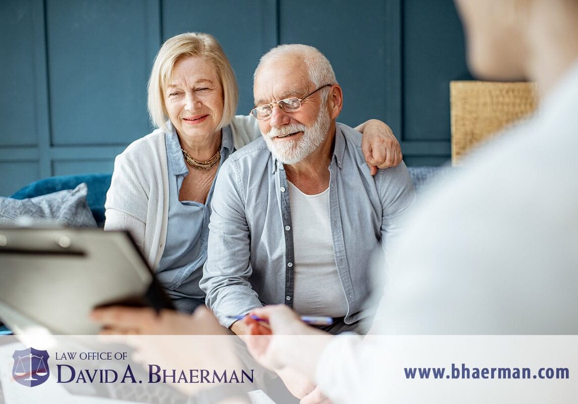 Elderly couple consulting with legal advisor.